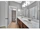 Bathroom with a double sink vanity, tiled floors, framed mirrors, and neutral paint at 314 Wave Crest Dr, Tega Cay, SC 29708
