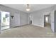 Carpeted bedroom with access to the balcony, neutral walls, and a modern light fixture at 314 Wave Crest Dr, Tega Cay, SC 29708