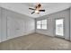 Bright bedroom featuring carpet flooring, a ceiling fan, and a window with blinds at 314 Wave Crest Dr, Tega Cay, SC 29708