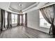 Dining room with decorative tray ceiling, large windows, and elegant chandelier at 314 Wave Crest Dr, Tega Cay, SC 29708