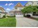 Beautiful two-story home with a two-car garage, stone accents, and a well-manicured lawn at 314 Wave Crest Dr, Tega Cay, SC 29708