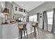 Modern kitchen bar area with barstool seating and views of the breakfast area with lots of light at 314 Wave Crest Dr, Tega Cay, SC 29708