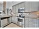 Well-equipped kitchen featuring stainless steel appliances, gray cabinets, and granite countertops at 314 Wave Crest Dr, Tega Cay, SC 29708