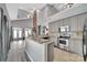 Spacious kitchen featuring stainless steel appliances, granite countertops, and a breakfast bar at 314 Wave Crest Dr, Tega Cay, SC 29708