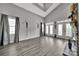 Spacious living room featuring vaulted ceilings, modern gray flooring, and bright windows with elegant curtains at 314 Wave Crest Dr, Tega Cay, SC 29708