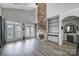 Bright open living room with soaring ceilings, stone fireplace, stylish built-ins, and modern flooring at 314 Wave Crest Dr, Tega Cay, SC 29708