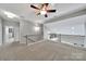Open loft area with plush carpeting, a ceiling fan, and views of the lower level at 314 Wave Crest Dr, Tega Cay, SC 29708