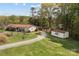 Aerial view of the property showcasing the house, outbuildings, and spacious green yard at 335 Ridgewood Dr, Mt Ulla, NC 28125