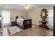 Cozy bedroom featuring a ceiling fan, wood flooring, and traditional furniture at 335 Ridgewood Dr, Mt Ulla, NC 28125