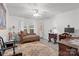 Comfortable bedroom featuring wood floors, a vintage chair, and a ceiling fan at 335 Ridgewood Dr, Mt Ulla, NC 28125
