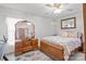Bedroom featuring wood floors, a ceiling fan, and a large decorative mirror at 335 Ridgewood Dr, Mt Ulla, NC 28125