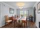 Traditional dining room with wood floors, natural light, classic decor, and comfortable seating for gatherings at 335 Ridgewood Dr, Mt Ulla, NC 28125