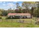 Single-story home with a well-maintained lawn, screened porch, attractive landscaping and an outbuilding at 335 Ridgewood Dr, Mt Ulla, NC 28125