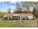 Charming home with a fenced front yard and outdoor seating area, perfect for relaxing and entertaining at 335 Ridgewood Dr, Mt Ulla, NC 28125