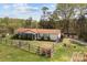 Charming single-story home features a fenced yard, screened porch and a cozy outdoor fire pit area at 335 Ridgewood Dr, Mt Ulla, NC 28125