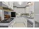 Functional kitchen offering white cabinets, gray counters, built-in appliances and a double basin stainless sink at 335 Ridgewood Dr, Mt Ulla, NC 28125