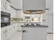 Functional kitchen with white cabinetry, gray counters, built-in appliances, and center island with cooktop at 335 Ridgewood Dr, Mt Ulla, NC 28125