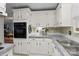 Bright kitchen featuring white cabinets, gray counters, built-in appliances, and efficient workspace at 335 Ridgewood Dr, Mt Ulla, NC 28125