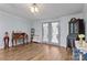 Spacious room with wood floor, decorative desk, and charming french doors to the back porch at 335 Ridgewood Dr, Mt Ulla, NC 28125