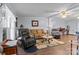 Cozy living room with wood floors, comfortable seating and a ceiling fan for year-round comfort at 335 Ridgewood Dr, Mt Ulla, NC 28125