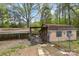Exterior view of the outbuilding with a fenced in area on a sunny day at 335 Ridgewood Dr, Mt Ulla, NC 28125
