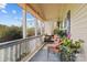 Covered porch with woven furniture and potted plants, offering a cozy and relaxing outdoor space at 335 Ridgewood Dr, Mt Ulla, NC 28125
