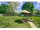 Well-maintained backyard with lush green grass, patio area, and tall trees at 3612 Cobbleridge Dr, Charlotte, NC 28215