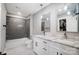 Bright bathroom featuring double sink vanity, marble floors, and tiled shower at 3612 Cobbleridge Dr, Charlotte, NC 28215