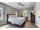 Cozy bedroom with wood floors, a comfortable bed, and natural light at 3612 Cobbleridge Dr, Charlotte, NC 28215
