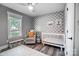 Bedroom features patterned accent wall and glider at 3612 Cobbleridge Dr, Charlotte, NC 28215