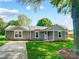 Charming one-story home with a well-manicured lawn, light gray siding, and a covered front porch at 3612 Cobbleridge Dr, Charlotte, NC 28215