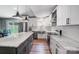 Beautiful white kitchen featuring an island with a gray base, stainless appliances, and marble countertops at 3612 Cobbleridge Dr, Charlotte, NC 28215
