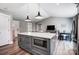 Open-concept kitchen with gray island, marble countertops, and seamless transition to the living area at 3612 Cobbleridge Dr, Charlotte, NC 28215