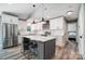 Bright kitchen featuring a gray kitchen island, modern appliances, and sleek white cabinetry at 3612 Cobbleridge Dr, Charlotte, NC 28215