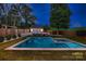 Night view of the in-ground pool, separate garage and landscaped yard in the backyard at 3709 Commonwealth Ave, Charlotte, NC 28205