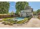 Large backyard with inground pool, surrounding patio area, privacy fence and lush landscaping at 3709 Commonwealth Ave, Charlotte, NC 28205