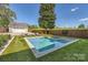 The backyard features an in-ground pool, a separate garage, and lush landscaping at 3709 Commonwealth Ave, Charlotte, NC 28205