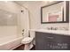 Updated bathroom features modern vanity, toilet, tub and beautiful tile at 3709 Commonwealth Ave, Charlotte, NC 28205