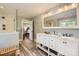 Elegant bathroom featuring dual vanity, glass shower, and natural light at 3709 Commonwealth Ave, Charlotte, NC 28205