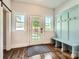Welcoming foyer with bench seating, coat hooks and view of the backyard through the glass front door at 3709 Commonwealth Ave, Charlotte, NC 28205