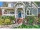 Inviting front entrance with a blue door, brick steps, and lush landscaping at 3709 Commonwealth Ave, Charlotte, NC 28205