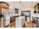 Modern kitchen featuring stainless steel appliances, a center island, and hardwood floors at 3709 Commonwealth Ave, Charlotte, NC 28205