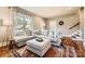 Comfortable living area featuring a large sectional sofa and hardwood flooring at 3709 Commonwealth Ave, Charlotte, NC 28205
