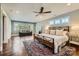 Spacious primary bedroom with large windows, wood floors, and ceiling fan at 3709 Commonwealth Ave, Charlotte, NC 28205