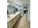 Spacious bathroom featuring a double vanity, large mirror, and a glass-enclosed shower at 3713 Saint Regis Dr, Gastonia, NC 28056