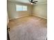 Spacious bedroom with a ceiling fan and neutral-toned walls and carpet at 3713 Saint Regis Dr, Gastonia, NC 28056