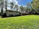 Ranch-style home boasting a lush green lawn and mature landscaping at 3713 Saint Regis Dr, Gastonia, NC 28056