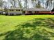 Ranch-style home boasting a lush green lawn and mature landscaping at 3713 Saint Regis Dr, Gastonia, NC 28056