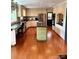 Spacious kitchen with a center island, hardwood floors, and stainless steel appliances at 3713 Saint Regis Dr, Gastonia, NC 28056