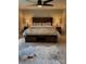 Comfortable main bedroom featuring a rustic wood bed frame, ceiling fan, and matching end tables at 3713 Saint Regis Dr, Gastonia, NC 28056